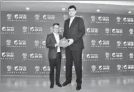  ?? PROVIDED TO CHINA DAILY ?? CBA president Yao Ming presents an autographe­d basketball to Sun Bo, senior vice-president of Ctrip at last week’s signing ceremony that made the Ctrip the official travel sponsor of the Chinese Basketball Associatio­n.