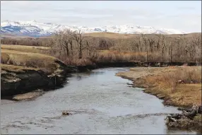  ?? Associated Press photo ?? In this March 2016 photo, snow-capped peaks in the Badger-Two Medicine portion of the Lewis and Clark National Forest rise above the Two Medicine River as it flows through the Blackfeet Indian Reservatio­n near Browning, MT. U.S. Interior Secretary Ryan...