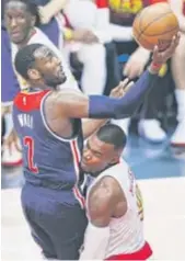  ?? | AP ?? Wizards guard JohnWall ( driving into Hawks forward Paul Millsap) had 42 points Friday in Atlanta.