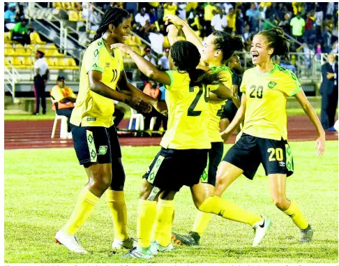  ?? FILE PHOTOS ?? The Reggae Girlz celebrate after Khadija Shaw (left) scored her second goal to give Jamaica the lead in their recent friendly internatio­nal against Chile at the Montego Bay Sports Complex.