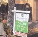  ?? STEVE SINOVIC/JOURNAL ?? A for-sale sign marks this property in Bear Canyon. The state’s housing market started 2018 with higher prices and fewer homes for sale.