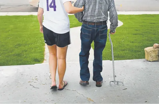  ?? Photos by RJ Sangosti, The Denver Post ?? Paige Brown, 18, helps 91-year-old Bob Hansen walk to the car in Wray, the eastern Colorado town where they live. “It is so incredible in this little town to have such amazing caregivers, but that Paige is something special. He is going to miss her,” says Kris Leighton, Hansen’s daughter.