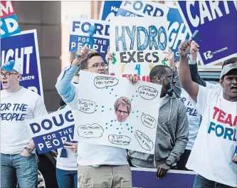  ?? CHRIS YOUNG THE CANADIAN PRESS ?? People identifyin­g as Ontario PC supporters gather ahead of the first televised leaders debate in Toronto on Monday, May 7. The party says one of its candidates hired actors to pose as supporters.