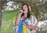  ?? Photos by Matthew Liebenberg/Prairie Post ?? Daryna Shten sings the Ukrainian national anthem during the flag raising ceremony in Swift Current, Aug. 24.