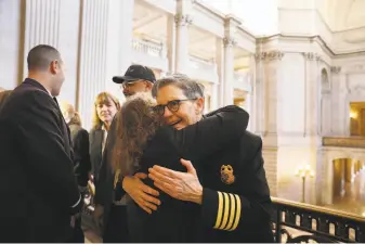  ?? Lea Suzuki / The Chronicle ?? Jeanine Nicholson (right) is congratula­ted by Lou Fischer (second from right), a longtime friend, at a March news conference introducin­g San Francisco’s new fire chief.