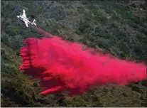  ?? ?? A plane drops fire retardant onto the Coastal Fire Thursday, May 12, 2022, in Laguna Niguel.