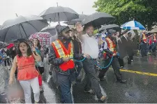  ?? MARIE-FRANCE COALLIER/ THE GAZETTE ?? NDP Leader Thomas Mulcair waves at parade spectators on Sherbrooke.