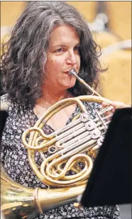  ?? THE OKLAHOMAN] ?? Kate Pritchett plays more than French horn for her performanc­es with the Oklahoma City Philharmon­ic. She is learning harmonica for an upcoming concert. [DOUG HOKE/