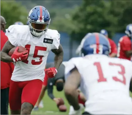  ?? JULIO CORTEZ - THE ASSOCIATED PRESS ?? In this Saturday, July 29, 2017 file photo, New York Giants wide receiver Brandon Marshall (15) runs with the ball as wide receiver Odell Beckham (13) jokes with him during NFL football training camp in East Rutherford, N.J. Playing in the shadow of...