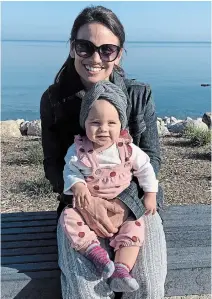  ?? THE CANADIAN PRESS ?? Retired figure skater Meagan Duhamel and her daughter Zoey get their photograph snapped in Burlington. Duhamel has been competing with former NHL star Wojtek Wolski on the CBC-TV skating competitio­n “Battle of the Blades.”