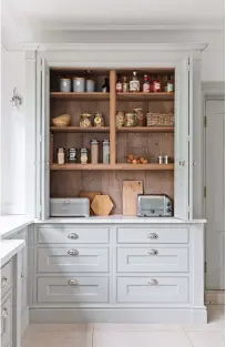 ?? ?? ABOVE ‘The breakfast cupboard is a fab design feature, as the tea, coffee, toaster and so on are all in one place. The bi-fold doors are nifty too, as they don’t protrude when open.’ Cabinetry in Lamp Room Gray modern eggshell, £73 for 2.5ltr, Farrow & Ball
