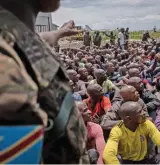  ?? (AFP) ?? Volunteers sit at Goma Airport responding to DR Congo’s President Felix Tshisekedi’s call to join the army, on Monday