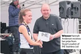  ??  ?? WinnerHann­ah Anderson receives her prize from Stuart Loudon of IHE Stainless Ltd