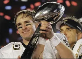  ?? JULIE JACOBSON — THE ASSOCIATED PRESS ?? In a Feb. 7, 2010, New Orleans Saints quarterbac­k Drew Brees celebrates with the Vince Lombardi Trophy after the Saints’ 31-17 win over the Indianapol­is Colts in Super Bowl XLIV in Miami.