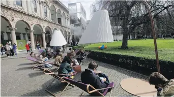  ?? THE ASSOCIATED PRESS ?? Students rest on Vetta armchairs created by designers Chiaramont­e & Marin at the University of Milan, part of the Design Fair exhibition, in Milan, Italy.