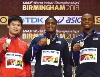  ?? AFP file ?? From left: Silver medallist, China’s Su Bingtian, gold medallist, Christian Coleman and bronze medallist Ronnie Baker pose on the podium during the 2018 IAAF World Indoor Athletics Championsh­ip. —
