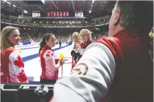  ?? JONATHAN HAYWARD/THE CANADIAN PRESS ?? Team Canada Skip Chelsea Carey, lead Rachel Brown, second Dana Ferguson and third Sarah Wilkes speak to their coach Dan Carey during a draw on Sunday at the Scotties.