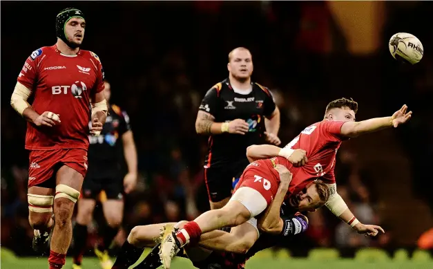  ?? PICTURE: Harry Trump/getty Images ?? Tom Prydie, pictured tackling Scarlets’ Steff Evans for Newport Gwent Dragons in the 2017 Pro12, has been offered a trial contract at Bath