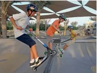  ??  ?? RISE UP... Scooter riders trying to hone their adventure skills gliding on the soft-ended walls at the XDubai Skatepark.