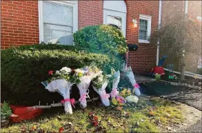  ?? Ethan Fry / Hearst Connecticu­t Media ?? Bouquets of flowers were placed in front the Salem Walk home where Julie Minogue was killed Tuesday night.