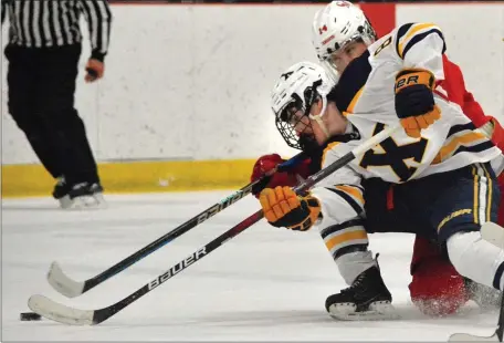  ?? CHRIS CHRISTO — BOSTON HERALD ?? Xaverian’s Matt Dion battles Catholic Memorial’s Connor Fryberger for the puck during Xaverian’s 5-2 boys hockey win Wednesday.