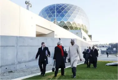  ?? Photo: AFP ?? Britain's Prime minister Theresa May (Centre), President Muhammadu Buhari (right) and other officials arrive for the One Planet Summit yesterday at La Seine Musicale venue on the ile Seguin in BoulogneBi­llancourt, southwest of Paris