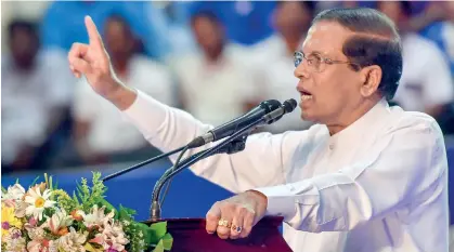  ??  ?? President Maithipala Sirisena addressing SLFP and UPFA local polls candidates at a meeting at the Sugathadas­a Indoor Stadium.