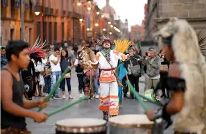  ??  ?? aboveAztec street performers are seen Feb. 18 in Zocalo in MexicoCity.