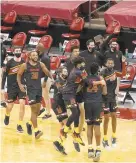  ?? MORRY GASH/ AP ?? The Maryland bench reacts after the Terps’ 70- 64 upset of No. 6 Wisconsin on the road on Monday night.