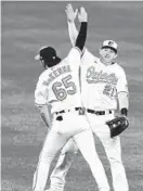  ?? WILLIAMS/AP TERRANCE ?? Orioles left fielder Ryan McKenna, right fielder Austin Hays (21) celebrate a victory over the Yankees on Monday night.