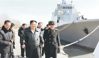  ?? — AFP photo ?? This undated photo shows Kim Jong Un (centre) inspecting the Nampho Dockyard in North Korea.