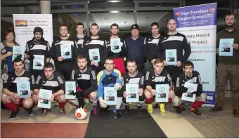  ??  ?? STSG United players hold a photo shoot with posters carrying the slogan “Give domestic violence the red card.’ at an event last Wednesday in the IT astro turf pitch.