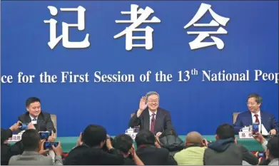  ?? FENG YONGBIN / CHINA DAILY ?? Zhou Xiaochuan (center), governor of the People’s Bank of China, answers reporters’ queries at a news conference on Friday on the sidelines of the first session of the 13th National People’s Congress.