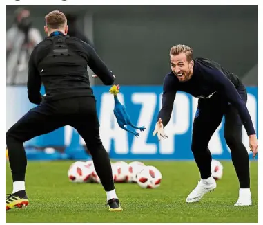  ??  ?? Catch it!: England’s forward Harry Kane (right) throwing a toy rooster to defender Phil Jones as they take part in a training session in Repino yesterday ahead of their semi-final match against Croatia today. — AFP