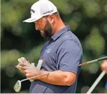  ?? AP PHOTO/BRYNN ANDERSON ?? Jon Rahm prepares to putt on the second hole at East Lake Golf Club during the second round of the season-ending Tour Championsh­ip on Friday in Atlanta. Rahm trailed 36-hole leader Patrick Cantlay by a shot.