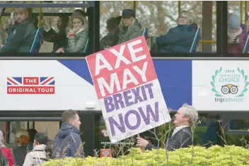  ?? — AFP ?? A pro-brexit supporter stands with a placard demanding that Britain’s Prime Minister Theresa May be sacked, near the Houses of Parliament in London on Friday.