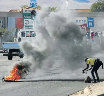  ?? Picture: ALON SKUY ?? ROAD SIGN: A road was blockaded in Mamelodi, Tshwane, as residents took to the streets in protest against the announceme­nt that incumbent Kgosientso Ramokgopa would be replaced as mayoral candidate by Thoko Didiza