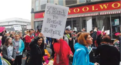  ??  ?? NORTH CAROLINA: Protestors march past the Civil Rights Museum during the Triad NC Womenís March in Greensboro, North Carolina. —AP