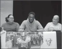  ?? The Sentinel-Record/Richard Rasmussen ?? BUFFALO BACK: Hot Springs senior Damien Walker, center, was joined by his mother Windy Whitely, left, and grandmothe­r Debbie Whitely Wednesday morning in the Johnnie Mae Mackey Theatre as he signed to play football at Arkansas Baptist College.