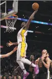  ?? Mark J. Terrill / Associated Press ?? The Lakers’ Julius Randle dunks in front of Jeff Green (center) and Larry Nance Jr.