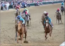  ?? MICHAEL REAVES — GETTY IMAGES ?? Mage (8), ridden by jockey Javier Castellano, crosses the finish line to win the 149th running of the Kentucky Derby at Churchill Downs on Saturday in Louisville, Ky.