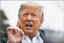  ?? Evan Vucci / Associated Press ?? President Donald Trump talks with reporters outside the White House on Friday in Washington.