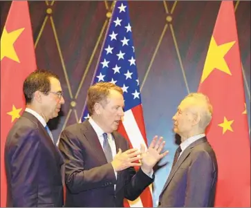  ?? Ng Han Guan AFP/Getty Images ?? U.S. TRADE Representa­tive Robert Lighthizer, center, and Treasury Secretary Steven T. Mnuchin, meet with China’s vice premier, Liu He, on Wednesday. The talks were “constructi­ve,” the White House said.