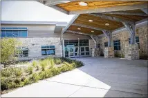  ??  ?? Collins’ campus incorporat­es elements designed to symbolize nearby McKinney Falls State Park, including blue accents and rippling textures to represent water, limestone and wood.