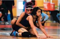  ?? BRANT PARSONS PHOTO ?? Oak Ridge’s Malaicka Pierre-Louis wrestles against Orlando University’s Ally Blake in the 122-pound final of the 2020 Metro Conference Championsh­ips for girls wrestling.