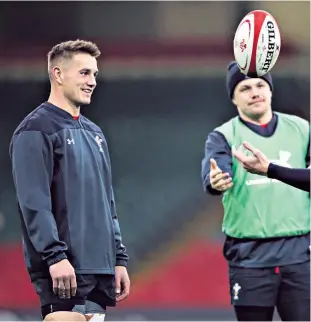  ??  ?? New ball game: Jonathan Davies (left) and Dan Biggar share a joke as Steff Evans (centre) loooks on as Wales trained in Cardiff yesterday