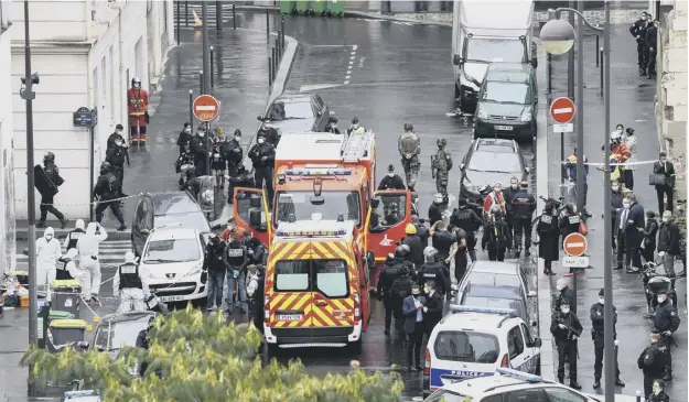  ?? PICTURES: ALAIN JOCARD/ GETTY ?? 0 Police and emergency services swamped the area near the former Charlie Hebdo offices after at least two people were injured in a knife attack