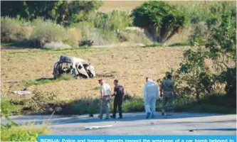  ??  ?? BIDNIJA: Police and forensic experts inspect the wreckage of a car bomb believed to have killed journalist and blogger Daphne Caruana Galizia close to her home in Bidnija, Malta, on October 16, 2017.— AFP