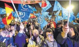  ?? AFP ?? Supporters of Spanish PM and Popular Party leader Mariano Rajoy outside party headquarte­rs.