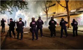  ?? Photograph: Amy Harris/Rex/Shuttersto­ck ?? Federal agents stand in the street firing tear gas, pepper balls and other dispersant­s overnight on Tuesday.